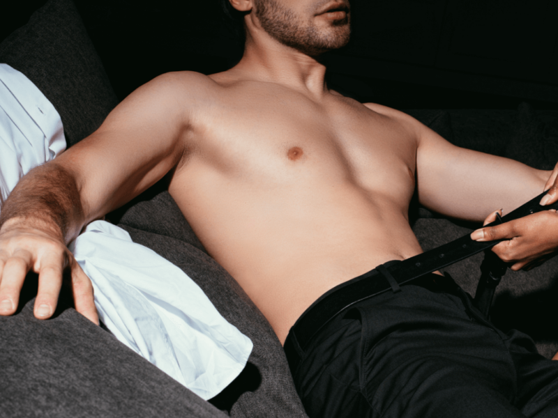 a man lying down on a couch. Somebody is opening his belt. Locktober - Keuschheit im Oktober Locktober - Chastity in October